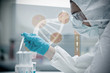 Chemist pouring liquid into test tubes