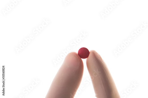 Photo: Gloved hand holding red tablet Gloved hand holding red tablet