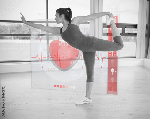 Photo: Woman in yoga pose with interface showing her heartbeat Woman in yoga pose with interface showing her heartbeat