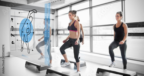 Photo: Women workout with blue interface showing them how to do Women workout with blue interface showing them how to do