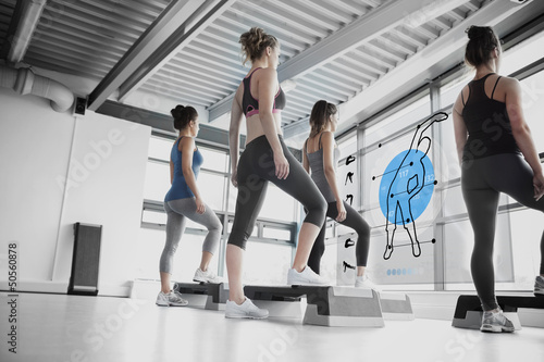 Photo: Rear view of women doing exercise with blue futuristic interface Rear view of women doing exercise with blue futuristic interface