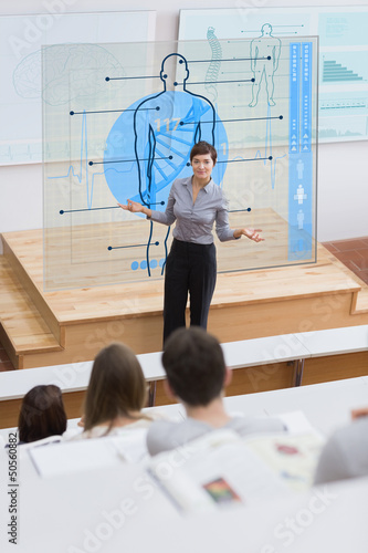 Photo: Standing teacher in front of futuristic interface asking a quest Standing teacher in front of futuristic interface asking a quest