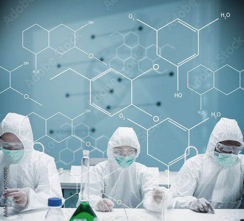 Photo: Chemists working in protective suit with futuristic interface sh Chemists working in protective suit with futuristic interface sh