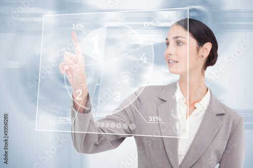 Photo: Businesswoman using nice transparent futuristic interface Businesswoman using nice transparent futuristic interface