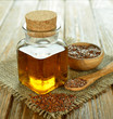 Linseed oil in a glass bottle on a brown table