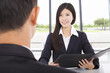 smiling businesswoman interviewing with businessman in office