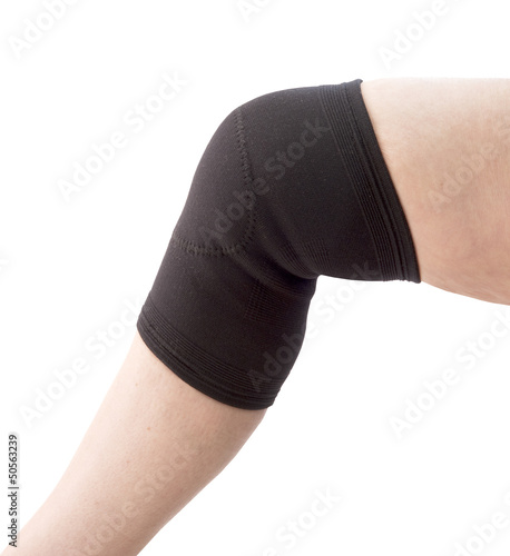 Photo: female senior with knee support on a white background female senior with knee support on a white background