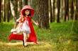 girl runs on the wood. the fairy tale " Red Riding Hood"