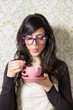 Vintage woman drinking steaming coffee