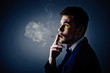 Dark portrait of the young beautiful man. The young man smokes c