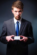 Business man handing a blank business card