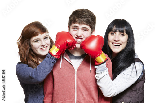 Photo: Teenage siblings fighting with boxing gloves Teenage siblings fighting with boxing gloves