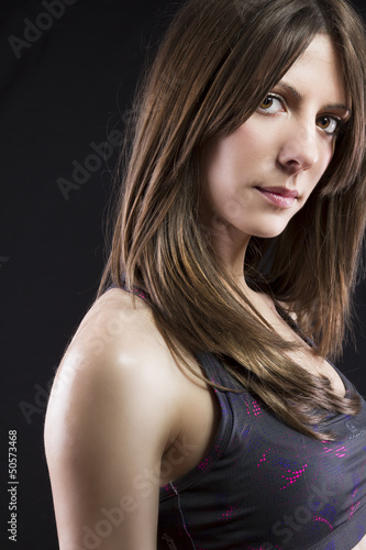 Photo: sport young woman face of fitness girl studio shot over black ba sport young woman face of fitness girl studio shot over black ba