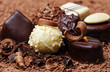 a chocolate background with pralines
