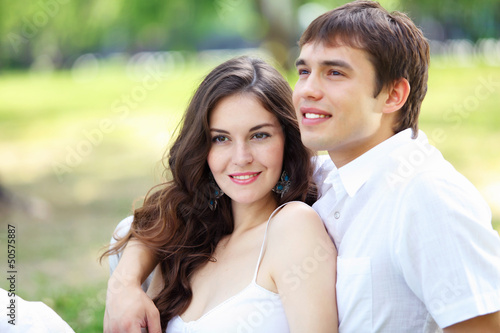 Photo: Young love Couple smiling under blue sky Young love Couple smiling under blue sky