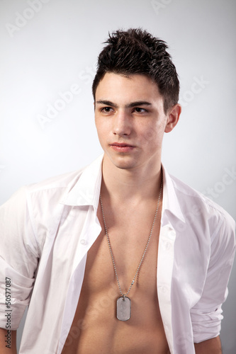 Photo: Healthy muscular young man on grey background Healthy muscular young man on grey background