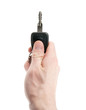 Hand holding car keys isolated on white background