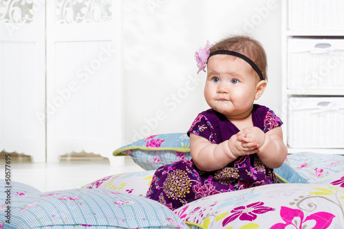 Photo: Baby sitting among pillows Baby sitting among pillows