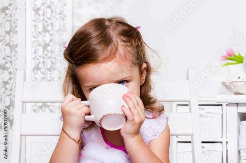 Photo: Preschool girl with a cup Preschool girl with a cup