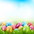 Easter background with colorful eggs in grass