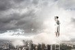 Businesswoman standing on ladder