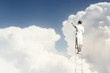Businesswoman standing on ladder