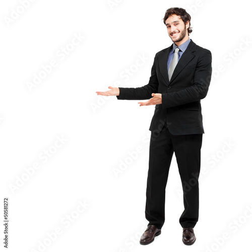 Photo: Full length businessman showing empty space Full length businessman showing empty space
