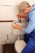 Handwerker repariert WC