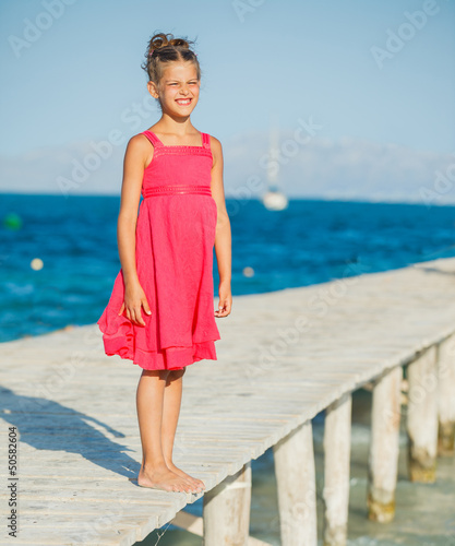 Photo: Girl walking on jetty Girl walking on jetty