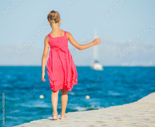 Photo: Girl walking on jetty Girl walking on jetty