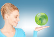 Photo: woman holding green globe on her hand woman holding green globe on her hand