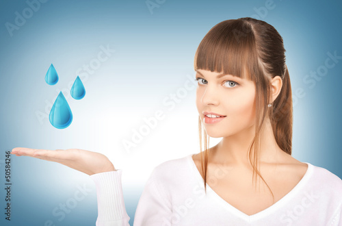 Photo: woman showing blue water drops woman showing blue water drops