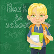 Cute schoolboy with textbooks near blackboard