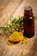 Bottle of aromatic essence oil, fresh and powdered rosemary