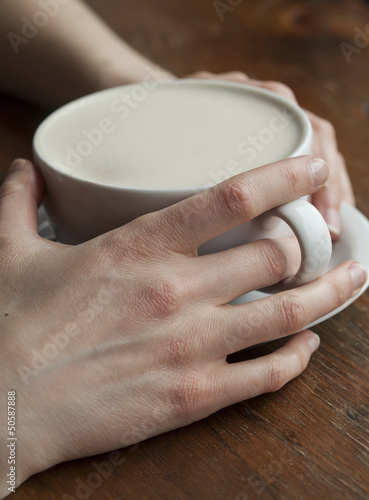 Photo: Woman Holding Her Morning Cup of Coffee Woman Holding Her Morning Cup of Coffee
