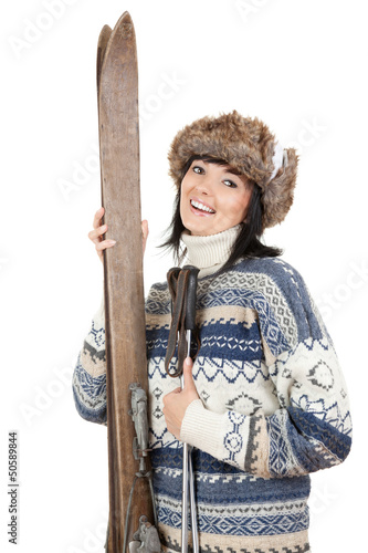 Photo: smiling woman in winter clothes with old wooden skis smiling woman in winter clothes with old wooden skis