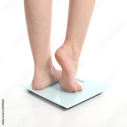 Photo: Beautiful woman legs on a scale Beautiful woman legs on a scale