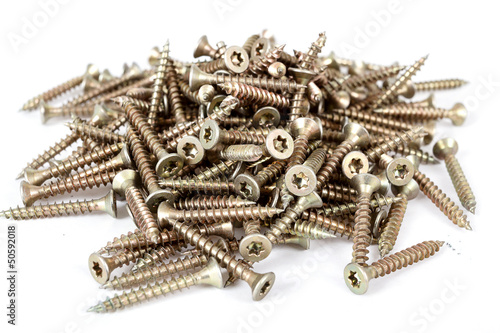 Photo: Closeup pile of screw on white Closeup pile of screw on white