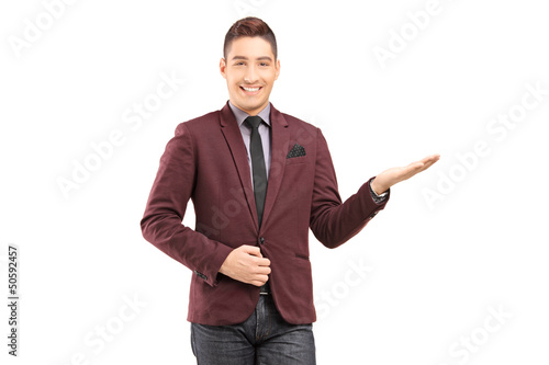 Photo: A stylish smiling male gesturing with his hand A stylish smiling male gesturing with his hand