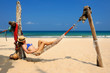 Woman in hammock on beach