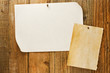 mottled beige paper naled to distressed wooden wall