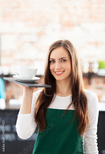 Photo: Portrait of waitress in cafe Portrait of waitress in cafe