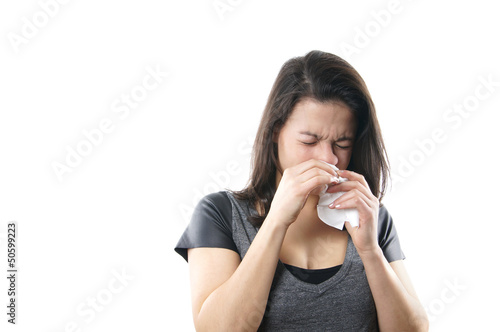 Photo: young woman blowing nose with paper tissue young woman blowing nose with paper tissue