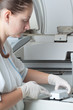 Woman loading samples in biochemical analyzer