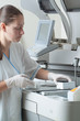 Woman loading samples in biochemical analyzer