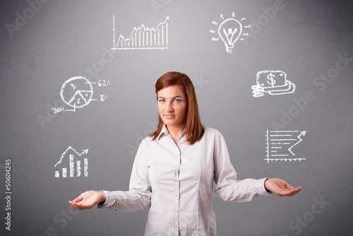 Photo: beautiful young woman juggling with statistics and graphs beautiful young woman juggling with statistics and graphs