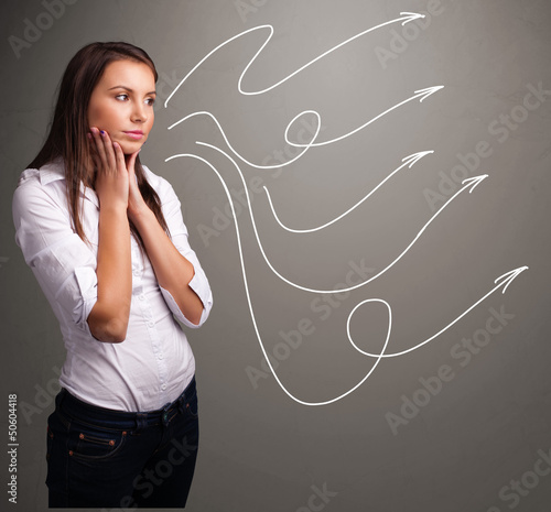 Photo: Attractive teenager looking at multiple curly arrows Attractive teenager looking at multiple curly arrows