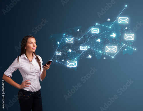Photo: Young lady holding a phone with arrows and message icons Young lady holding a phone with arrows and message icons