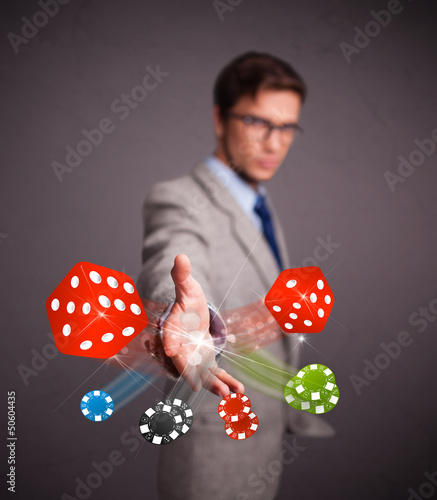 Photo: Attractive man throwing dices and chips Attractive man throwing dices and chips