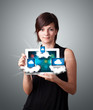 young woman holding tablet with modern devices in clouds